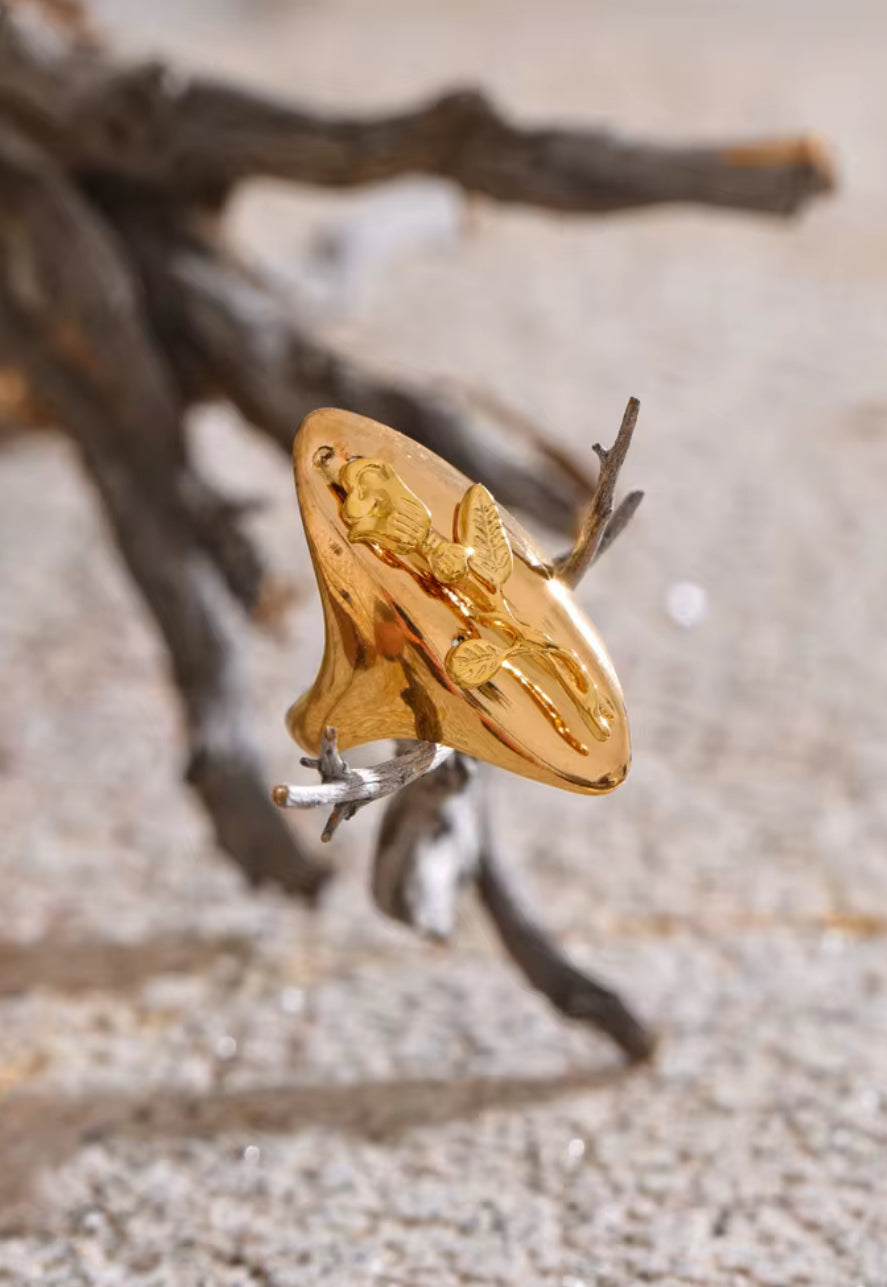 Gold ring with a butterfly design on a natural background. Gold-plated floral ring – hypoallergenic, adjustable, and tarnish-resistant.