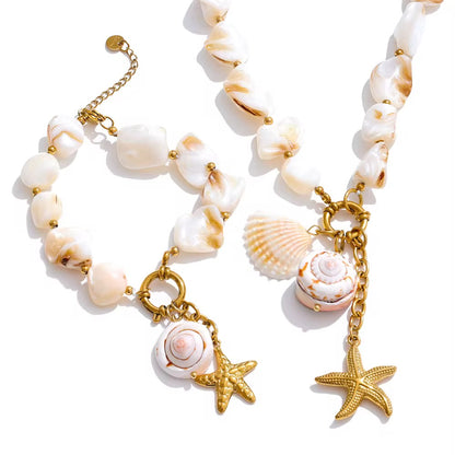 Necklace with shell and starfish charms on a white background. Delicate 18K gold shell pendant necklace – hypoallergenic jewelry for sensitive skin.