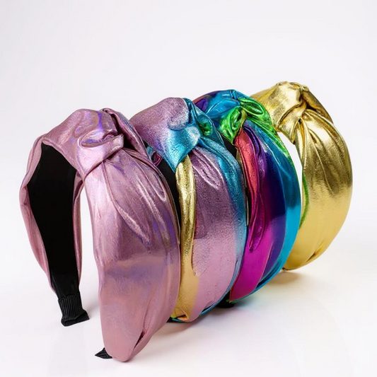 Colorful metallic headband with a unique design on a white background. Knotted pink headband for women with curly hair"
Girl wearing pearl hair clip	"Girl wearing pearl hair clip for elegant updo hairstyle"
Hair bows on table display	"Set of colorful hair bows for girls and women"
Mom and daughter wearing headbands	"Matching headbands for mom and daughter in soft fabric"